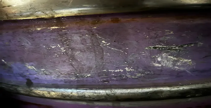 Falc na starom zničenom nerezovom sude